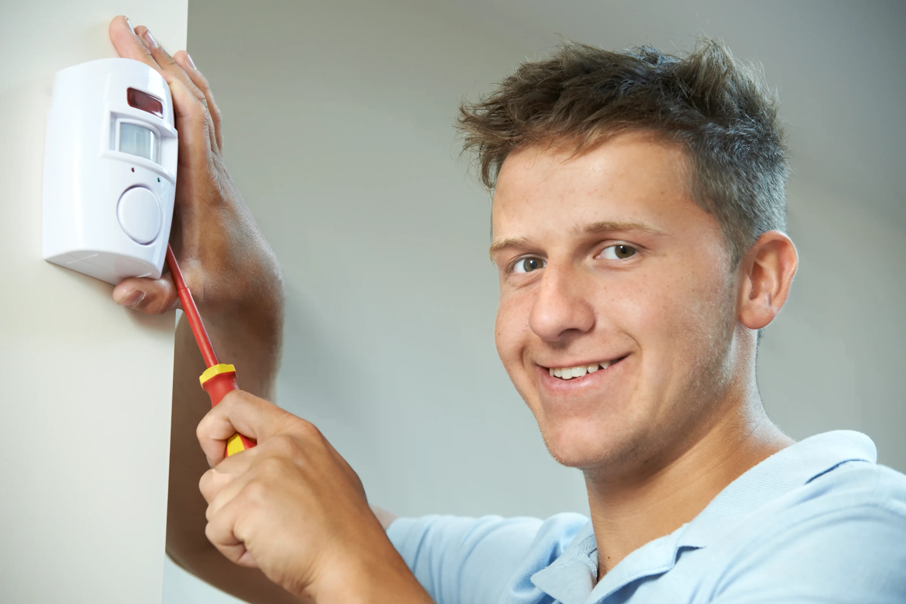 hombre instalando una alarma